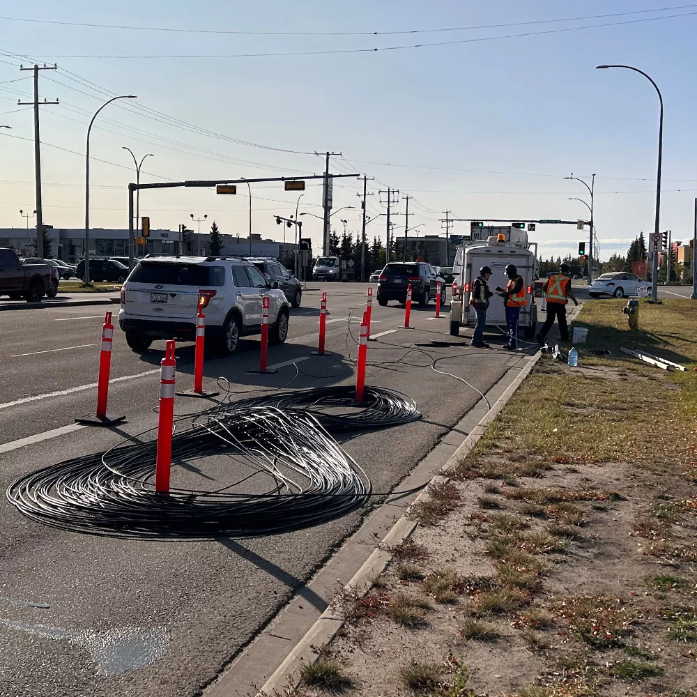 Roadway infrastructure installation with traffic control setup in Alberta