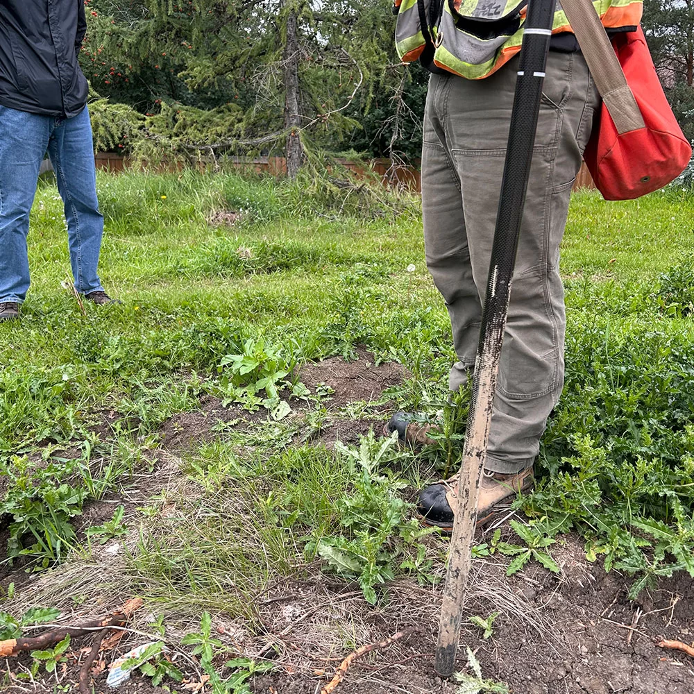 Field technician performing underground infrastructure testing and locating in Alberta