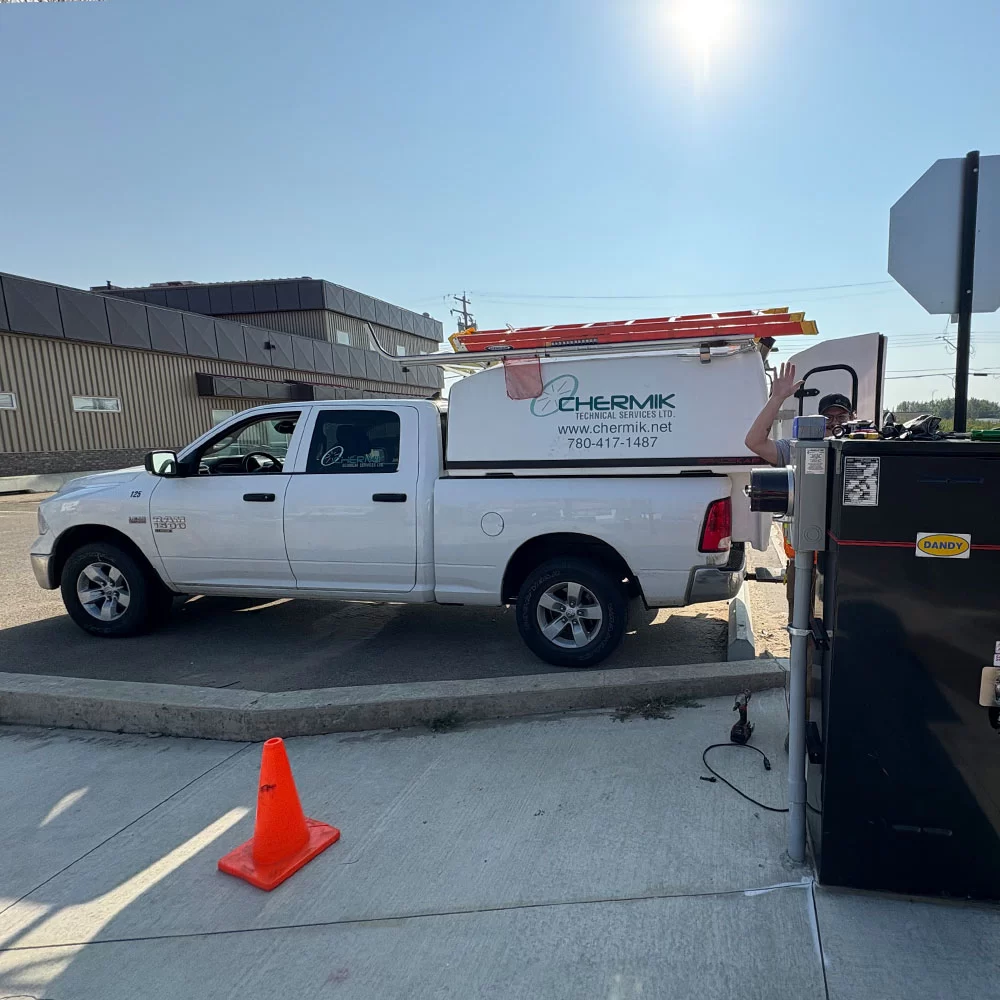 Infrastructure installation equipment staged on jobsite in Alberta with Chermik service vehicle
